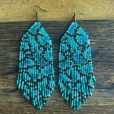 These Beautiful Handmade Beaded Earrings In Turquoise, Brown And White Colors. They Have A Granite Design. Measure From Top Of Hook To Bottom 5.5” And 1.75” Wide. These Are Great For Country Concerts, Festivals, Date Nights Or Just For Plain Fun. The Hook Is A Bronze Tone Color. Artisan Blue Round Beaded Earrings, Artisan Blue Beaded Earrings With Colorful Beads, Artisan Blue Earrings With Beaded Fringe, Blue Bohemian Beaded Chain Earrings, Artisan Turquoise Beaded Fringe Earrings, Turquoise Earrings With Beaded Chain And Round Beads, Turquoise Earrings With Beaded Chain, Blue Round Beads With Beaded Fringe, Granite Design