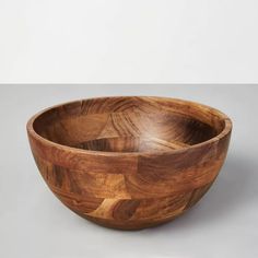 a wooden bowl sitting on top of a table