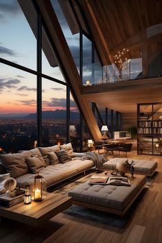 a living room filled with lots of furniture next to tall windows and floor to ceiling windows