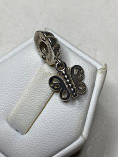 "The retired vintage Pandora \"Friends Forever\" butterfly charm is a beautiful and timeless piece of jewelry that makes for a thoughtful and sentimental gift for her. The charm is crafted from high-quality sterling silver, ensuring that it will last for years to come. As a vintage item, the charm may show some signs of wear and tear, which only adds to its charm and character. Despite this, the charm remains in good condition, ready to be added to her Pandora bracelet collection. The butterfly Charms Pandora, Bracelet Pandora, Women Bracelet, Pandora Charm, Bracelet Sterling Silver, Butterfly Charm, Bracelet Collection, Pandora Bracelet, Sentimental Gifts