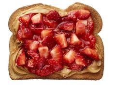 a toast with strawberries and peanut butter on it