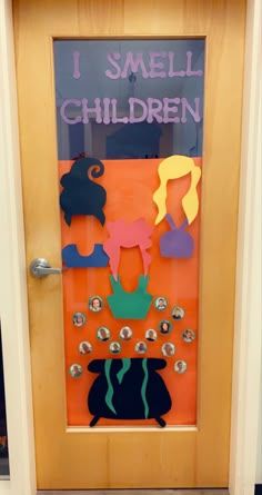 a door decorated with paper cutouts and magnets that says, i smell children