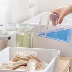 someone is pouring blue liquid into a container