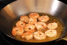 shrimp being cooked in a frying pan on the stove