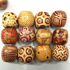 a group of wooden beads sitting on top of a white table next to each other