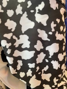 the back of a black and white cow print skirt