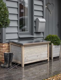 a wooden box sitting on the side of a house