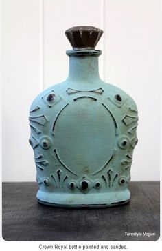 an old blue bottle sitting on top of a wooden table