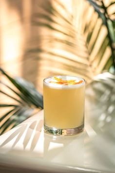 a drink sitting on top of a white table