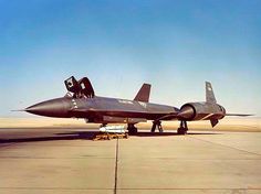 a fighter jet sitting on top of an airport tarmac