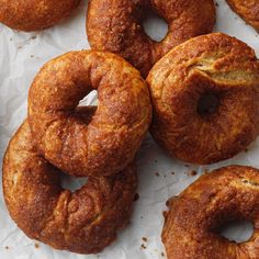 several doughnuts sitting on top of white paper