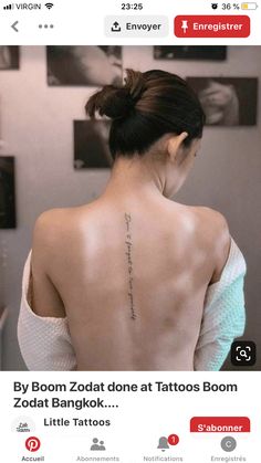 the back of a woman's neck with tattoos on her upper and lower back