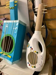 a white and blue instrument sitting on top of a counter next to other musical instruments