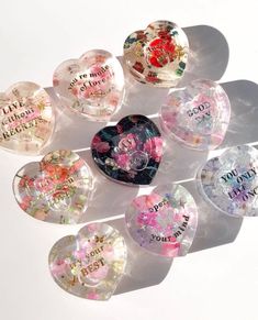 six heart shaped candy boxes with words on them