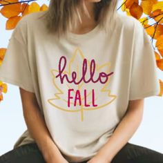 Say hello to fall in style with our Hello Fall Shirt! Whether you're enjoying a pumpkin spice latte or taking a leisurely stroll through the park, this shirt is the perfect companion for all your autumn adventures. Made from soft, comfortable fabric and featuring a trendy design, it's perfect for layering or wearing on its own. Embrace the warmth and beauty of the season with our Hello Fall Shirt and let your autumn vibes shine!  Please provide any personalization requests in the box below. The Casual Brown T-shirt For Fall, Trendy Fall Letter Print T-shirt, Trendy Letter Print T-shirt For Fall, Relaxed Fit T-shirt For Fall, White Tops For Fall, Brown Graphic Tee For Fall, Trendy Brown T-shirt For Fall, Fall Graphic Tee In Brown, Brown Letter Print T-shirt For Fall