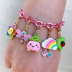 a person wearing a bracelet with charms on it