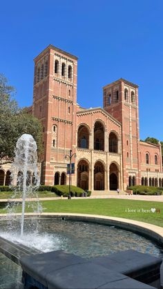 a fountain in front of a large building with two towers on it's sides