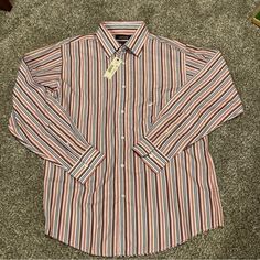 This Murano Men's Dress Shirt Is Perfect For Those Who Appreciate European Fabric And Stylish Design. The Multicolored Striped Pattern With Blue Accents Adds A Touch Of Sophistication To Your Casual Or Formal Outfit. The Long Sleeve Shirt Features A Button Closure And Is Made Of High-Quality Cotton Material. With A Regular Fit And Size Type, This Shirt Is Suitable For Most Men. The Shirt Is Brand New With Tags And Is A Great Addition To Your Wardrobe. Whether You're Going To A Party Or A Business Meeting, This Murano Dress Shirt Will Make You Look And Feel Confident. Colors Include Shades Of Blue, White, Orange, And Red Light Blue Dress Shirt, Long Sleeve Cotton Dress, Blue Striped Dress, Fitted Dress Shirts, Shirt Dress Style, Slim Fit Dresses, Business Dresses