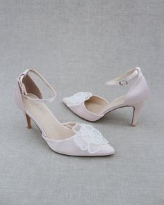 Classic satin pointy toe heels adorned with large white pearl primrose flower applique. Sleek and glamour is a great combination and will definitely be a favorite. DETAILS: HEELS: 3 inches COLORS AVAILABLE: Dusty Pink, Light Blue, Black, Champagne, Ivory, and White UPPER: Synthetic upper and lining MATERIALS: Manmade outsole ORIGIN: Imported STYLE NAME: BELL Low Heel Satin Wedding Heels, Satin Low Heel Wedding Heels, Elegant Satin Wedding Shoes, Satin Wedding Shoes With 4-inch Heel, Satin Closed-toe Wedding Shoes, High Heel Satin Wedding Shoes, Satin High Heel Wedding Shoes, Satin Closed Toe Wedding Shoes, Elegant Embellished Wedding Shoes For Bridesmaid