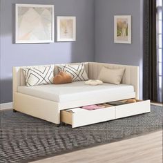 a living room with a white couch and drawers in the bottom drawer on the floor