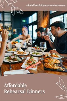 people sitting at a table with plates of food and wine glasses in front of them