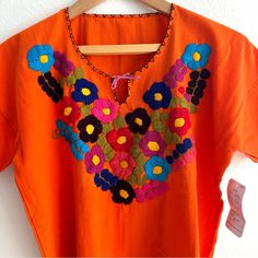 Brand New From Mexico Orange Embroidered Top Size Women’s Small Pink V-neck Top With Floral Embroidery, Spring Embroidered Orange Blouse, Orange Cotton Blouse With Floral Embroidery, Pink Folk Style Top For Spring, Pink Blouse With Embroidered Neckline For Spring, Spring Hippie Blouse With Floral Embroidery, Pink V-neck Embroidered Top With Floral Embroidery, Pink Folk Style Spring Blouse, Pink Folk Blouse For Spring