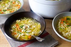 three bowls of chicken noodle soup on a table