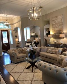 a living room filled with furniture and a chandelier