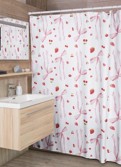 a bathroom with a sink, mirror and shower curtain that has strawberries on it