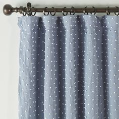 a blue curtain with white polka dots on it