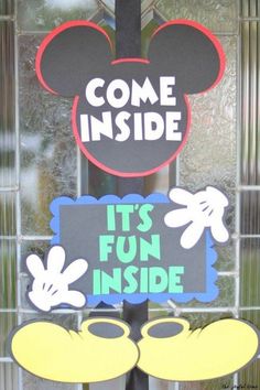 a mickey mouse door hanger with the words come inside and it's fun inside