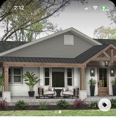 a small house with two chairs on the front porch