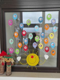 an image of a window decorated with balloons and stickers in the shape of a sun