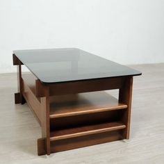 a glass table sitting on top of a hard wood floor