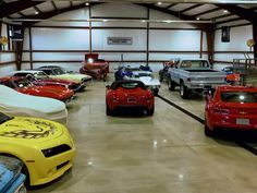 a garage filled with lots of different colored cars