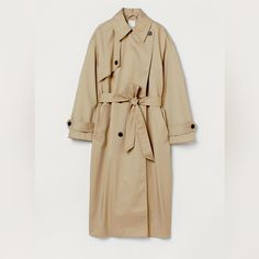 Calf-Length, Oversized, Double-Breasted Trenchcoat In Twill With A Slight Sheen. Notched Lapels, Yoke At One Side Of Front With A Button, And Welt Front Pockets. Dropped Shoulders, Wide Sleeves, And Cuffs With Tab And Decorative Button. Removable Tie Belt At Waist And A Vent At Back. Lined. Fit: Oversized Composition - Shell: Polyester 62%, Cotton 38%, Lining: 100% Polyester Chic Oversized H&m Outerwear, H&m Oversized Outerwear For Fall, Oversized H&m Outerwear For Work, H&m Classic Spring Outerwear, Pink Suede Jacket, Herringbone Tweed Jacket, Oversized Trench, Lightweight Trench Coat, Suede Trench Coat