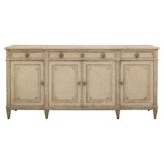 an antique style sideboard with four doors and two drawers, in cream colored wood