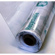 a roll of clear plastic wrapper sitting on top of a white tablecloth covered floor