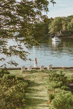 a bride and groom are standing in front of the water