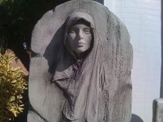 a statue of a woman wrapped in a blanket