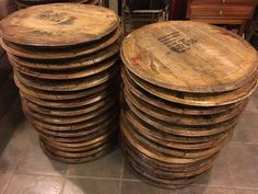 a stack of wooden barrels sitting on top of a tile floor next to a dresser