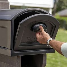 a man's hand pressing the button on a mailbox