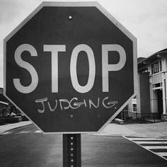 a black and white photo of a stop sign with the word utopia written on it