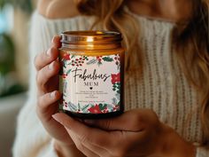 a woman holding a candle in her hands with the label fabulous vim on it