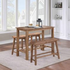 two wooden stools sit at the end of a table