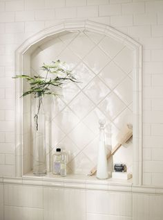 a vase with some flowers in it sitting on a shelf