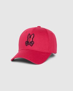 The MENS WALTER BASEBALL CAP - B6A800D200 by Psycho Bunny is made from 100% cotton and features a red design with a black embroidered logo depicting bunny ears above crossbones on the front. It has a curved brim and is designed for durability and comfort, making it an excellent choice for everyday wear, all set against a plain background. Casual Baseball Cap With Cotton Sweatband For Sports, Spring Sports Baseball Cap With Curved Bill, Spring Baseball Cap For Sports Events With Curved Bill, Pink Casual Snapback Hat For Baseball Season, Casual Pink Snapback Hat For Baseball Season, Spring Sports Events Baseball Cap With Curved Bill, Curved Brim Baseball Cap For Golf During Baseball Season, Breathable Cotton Baseball Cap For Sports, Breathable Cotton Sports Baseball Cap