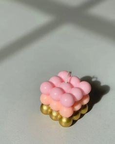 a pink and gold ring sitting on top of a table