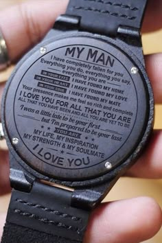 a wooden watch with the words i love you written on it's face in black leather