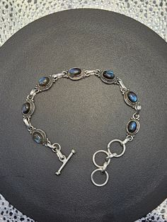 AAA quality blue labradorite bracelet with LOTS of blue flash both on the surface and deep inside the stones. Adjustable circle with T-bar fastener allows for multiple sizes and bangle or snug fit styles. .925 sterling silver setting. Even more stunning when struck by the sun's rays. *NOTE- You will receive exactly the bracelet pictured. Please send any questions to me before purchasing. Thank you for visiting my shop! Blue Labradorite Bracelet, Labradorite Bracelet, Blue Labradorite, Chain Link Bracelet, Link Bracelets, Chain Link, Snug Fit, Labradorite, Fitness Fashion